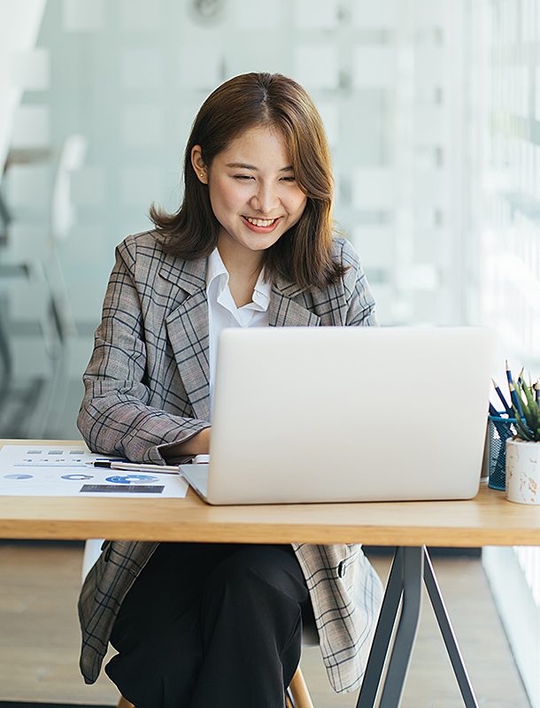 Happy, smiling woman working at laptop